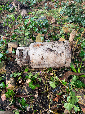 Butane gas cylinder dumped in a forest. February 2024