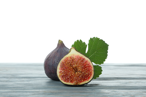 Fig on wooden table isolated on white background