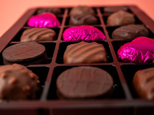 istock Box of chocolates on a pink background. 2039696752