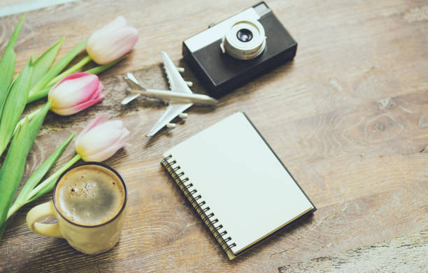 istock top view image of spring tulips next to old camera, mockup notebook on wooden table 2039696769