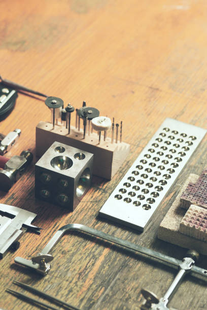 Working desk for craft jewelery making with professional tools. Still life of goldsmith's tools with rings.