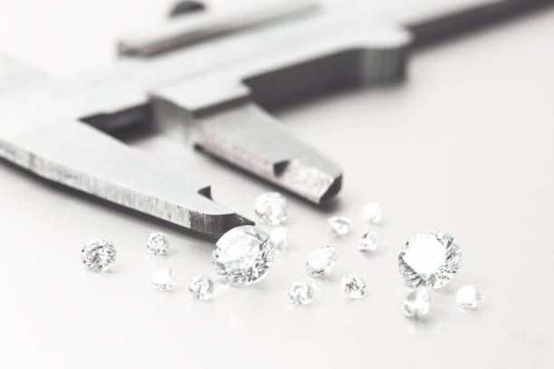 istock Macro close up of experienced goldsmith sorting high quality diamonds, selecting them to make precious jewels in workshop.Concept of jewelry,luxury,goldsmith, diamonds, brilliance. 2039697302