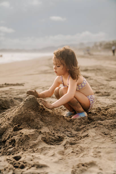 Girl playing at the beach