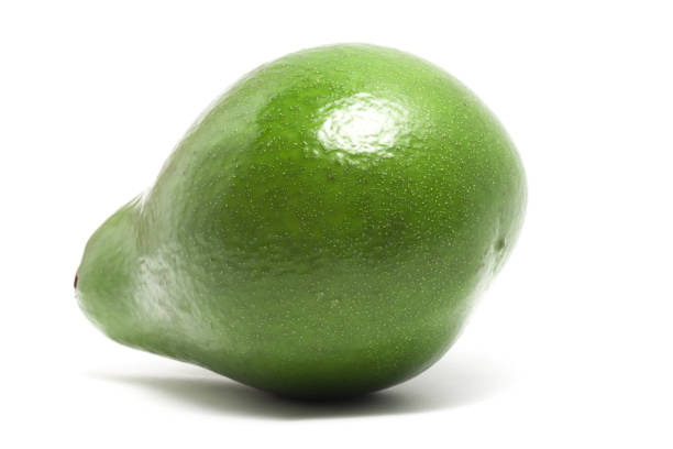 A whole fresh organic avocado delicious fruit side view isolated on white background clipping path