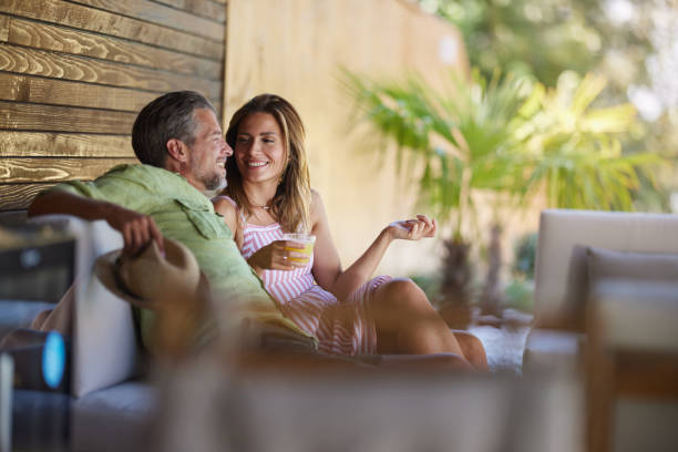 istock Happy couple talking while enjoying in summer day on a patio. 2039754434