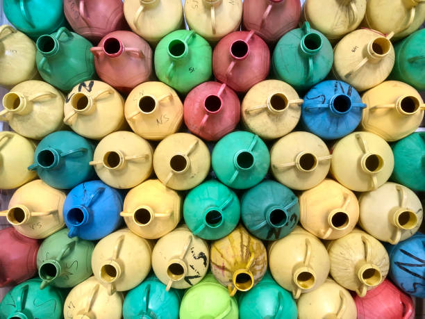 Heap of empty plastic olive oil barrels, Multi colored.