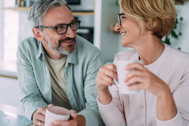 Lovely couple drinking coffee at home.