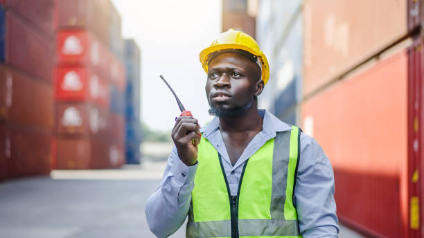 istock Dock foreman with a radio standing in front of cargo containers 2039772492