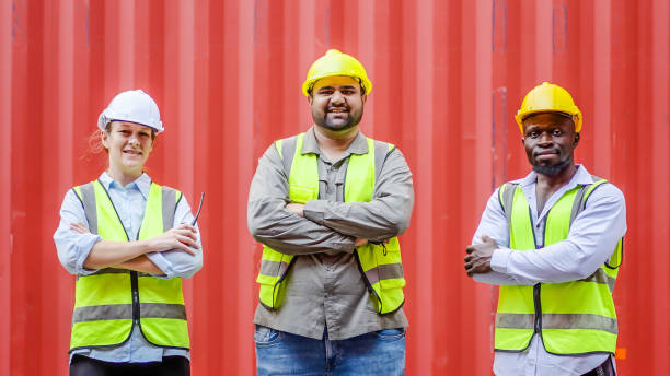 istock Dock workers standing in front of a red container in a logistics terminal 2039773586