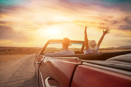happy people traveling in classic vintage car, couple during honeymoon