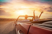 happy people traveling in classic vintage car, couple on honeymoon