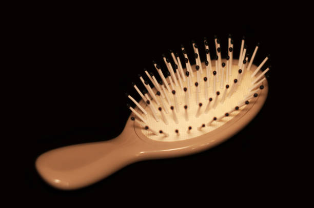 small comb for a girl, close up on a black background
