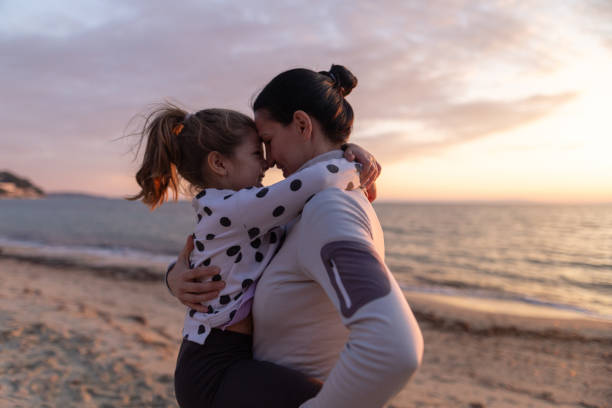 istock Mother and daughter bonding by the sea 2039797979