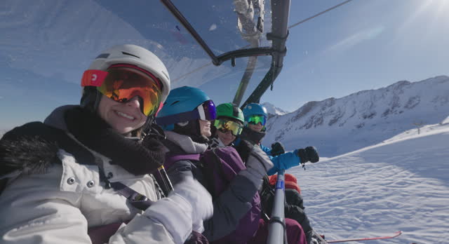 Family enjoying skiing at Austrian Alps glacier on a sunny winter day