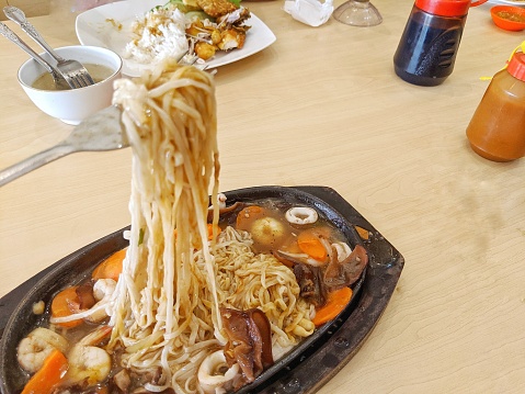 Hotplate noodles served hot on the dining table