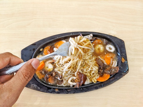 Hotplate noodles served hot on the dining table