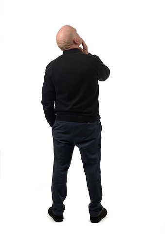 rear view of a man thinking and looking up on white background