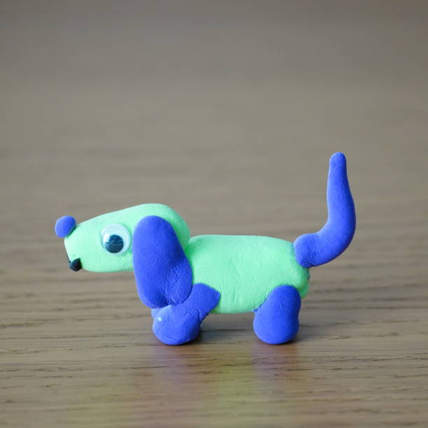 istock Toy dog on a wooden table, facing opposite the camera 2039848414