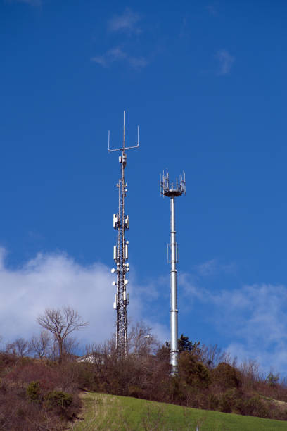 TV and telephone repeaters on a hill against the sky