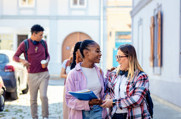 istock Diverse group of students is walking down the street. 2039905633