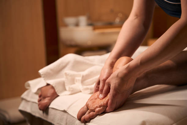 istock Acupressurist hands applying pressure to acupoint on man foot 2039940066