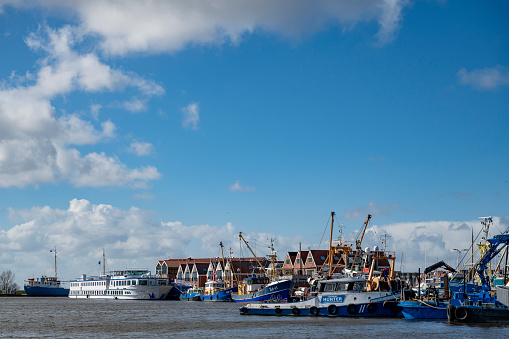 Ships in the harbor of the former island of Urk at the shore of IJsselmeer in Flevoland, The Netherlands during a sunny early springtime day.