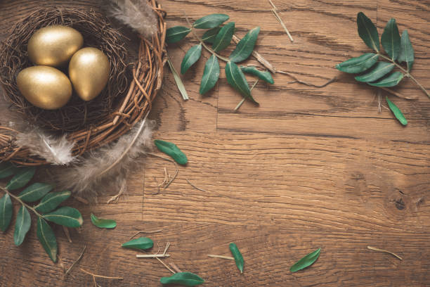 istock Gold eggs in nest from hay on wood boards with copyspace.Flat lay trendy easter. Happy easter card. Copy space for text 2039960970