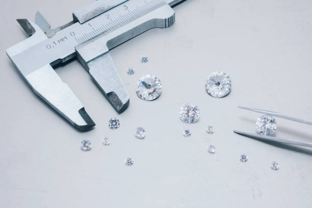 istock Macro close up of experienced goldsmith sorting high quality diamonds, selecting them to make precious jewels in workshop.Concept of jewelry,luxury,goldsmith, diamonds, brilliance. 2039968295