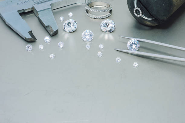 istock Macro close up of experienced goldsmith sorting high quality diamonds, selecting them to make precious jewels in workshop.Concept of jewelry,luxury,goldsmith, diamonds, brilliance. 2039969332