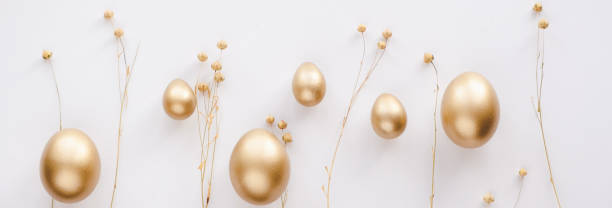 istock Stylish golden eggs easter concept. Easter gold eggs with golden dried flax linum bunch white background. Flat lay trendy easter. Happy easter card. Copy space for text 2039970454