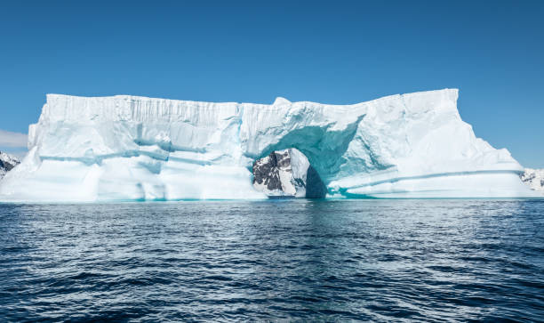 istock Massive tabular iceberg with arch shape. Booth Island, Antarctica. 2039973206