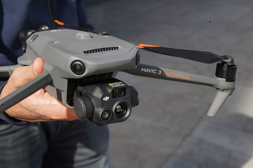 Detail of Dji Mavic 3T enterprise in the hands of the pilot. With two sensors in front and horizontal image