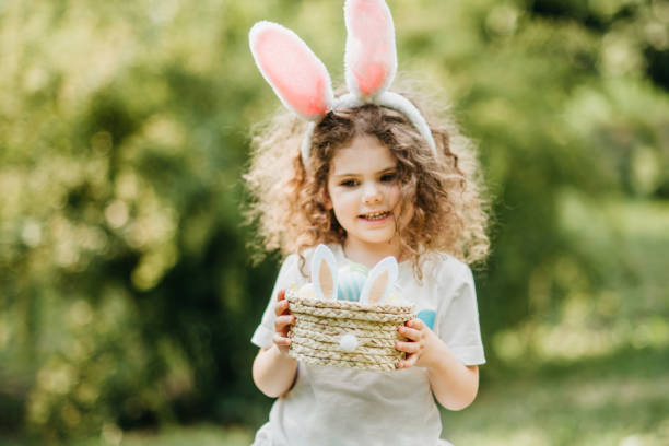 istock Baby with basket full of colorful eggs. Easter egg hunt. 2039976913