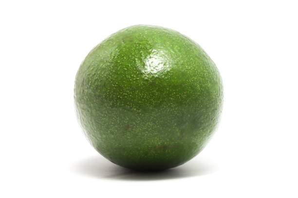 Group of whole green avocados stacked together on a clean white background, showcasing their natural texture and color.