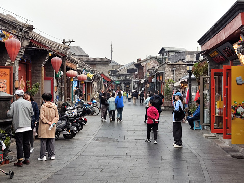 People walking in Yandaixie Street, a Hutong located in Beijing downtown. It is also the oldest business street in Beijing with a history of about 800 years.