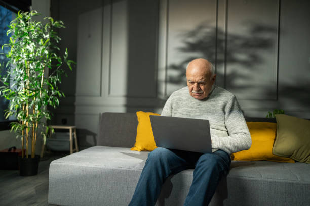 istock Senior man using laptop at home 2039989831