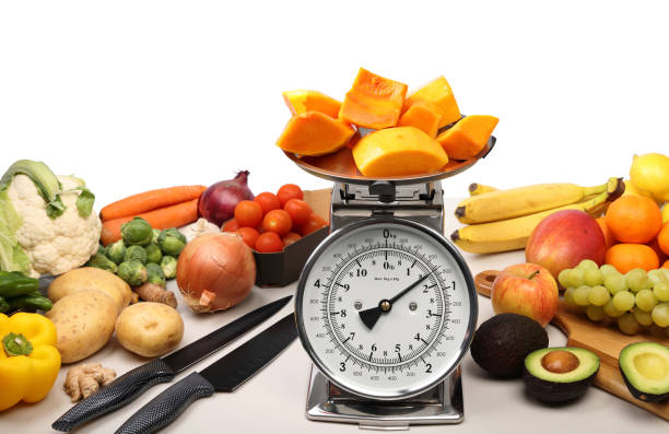Fruit and vegetables surrounding weighing Scales
