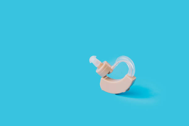 Hearing aid in the middle of a blue background.