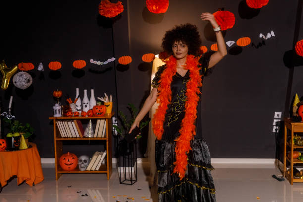 istock Young woman in a Halloween costume dancing 2040007079