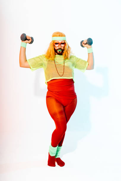 istock Crossdressed man with beard and glasses holding two dumbells 2040009254