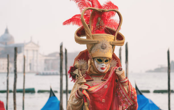 Venice, Italy - February 11, 2024: The Carnival of Venice (Italian: Carnevale di Venezia) is an annual festival held in Venice, Italy, famous throughout the world for its elaborate costumes and masks. \nThe Carnival ends on Shrove Tuesday (Martedì Grasso or Mardi Gras), which is the day before the start of Lent on Ash Wednesday (February-March).\nThe Carnival traces its origins to the Middle Ages, existing for several centuries until it was abolished in 1797. The tradition was revived in 1979, and the modern event now attracts approximately 3 million visitors annually.
