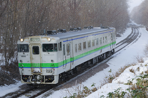Nanae-cho, Hokkaido, Japan - February 23, 2024 : KIHA 40 Local train running on curve