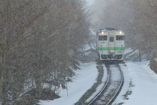 Nanae-cho, Hokkaido, Japan - February 23, 2024 : KIHA 40 Local train running on Hakodate line