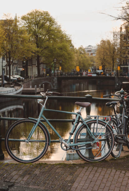 istock Iconic Amsterdam: Close-Up of Parked Bicycle by Canal 2040034553