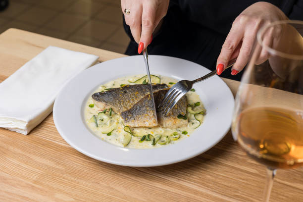 istock Baked fish with zucchini and dill on a white plate 2040036127