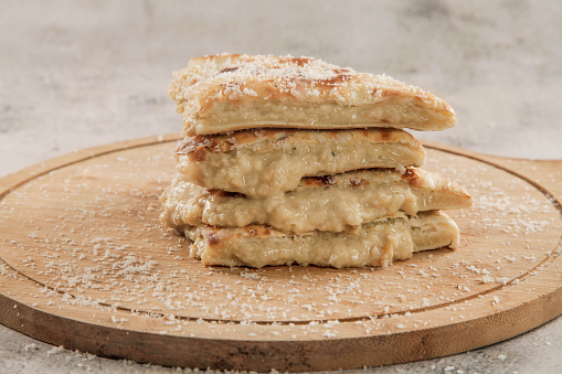 Sweet rabri stuffed naan, made in condensed milk with coconut toppings pistachio and cardamom.