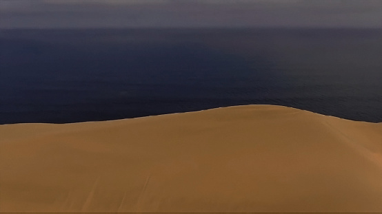 Woman standing in white desert sand dunes