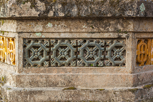Photograph of traditional Vietnamese ventilation block pattern on an ancient stone wall