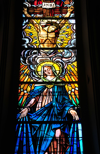 Mahébourg, Grand Port District, Mauritius: Notre Dame Des Anges, backlit stained glass window displaying Jesus Christ and the Virgin Mary, framed by angels.
