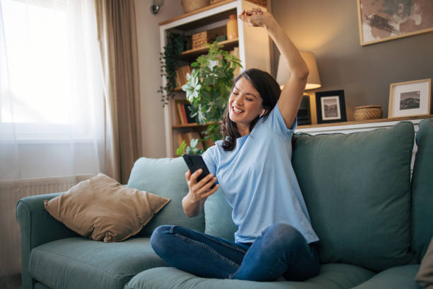 istock Woman sitting at the sofa and singing. 2040067784